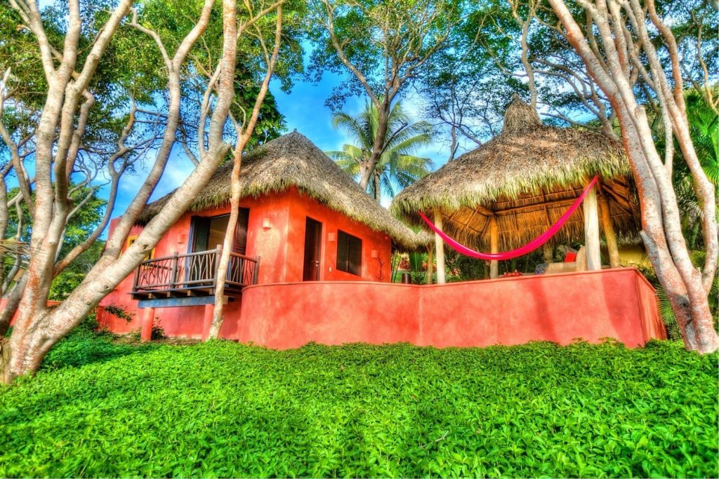Casa Mis Amores Sprawling thatchedroof estate at the ocean's edge.
